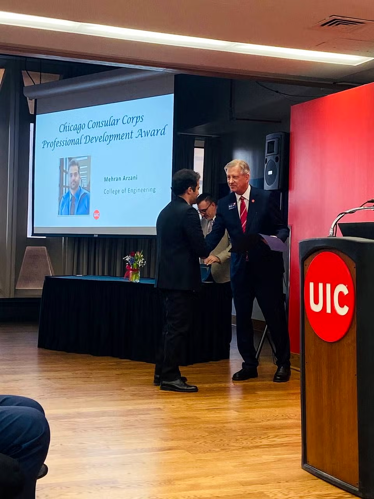 Mehran Arzani receiving the Chicago Consular Corps Professional Development Award at UIC