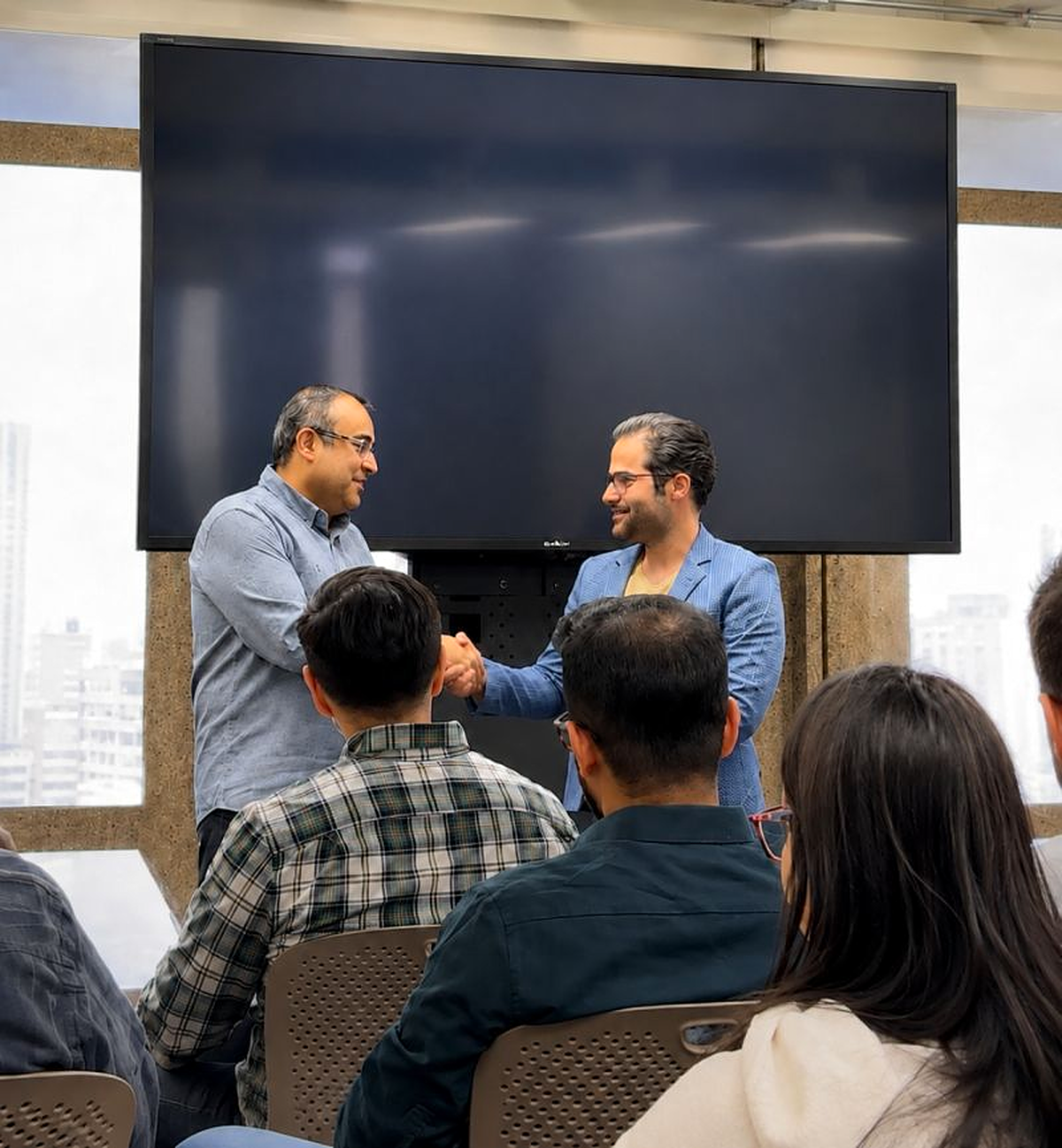 Mehran Arzani receiving recognition during a UIC award ceremony
